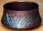 Carved bowl with red glaze, 9" diameter.